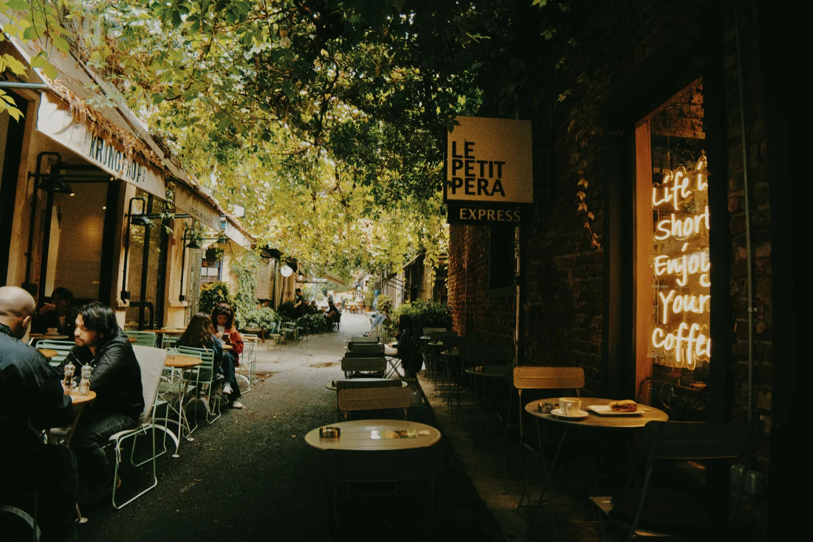 Leafy laneway cafe with outdoor tables