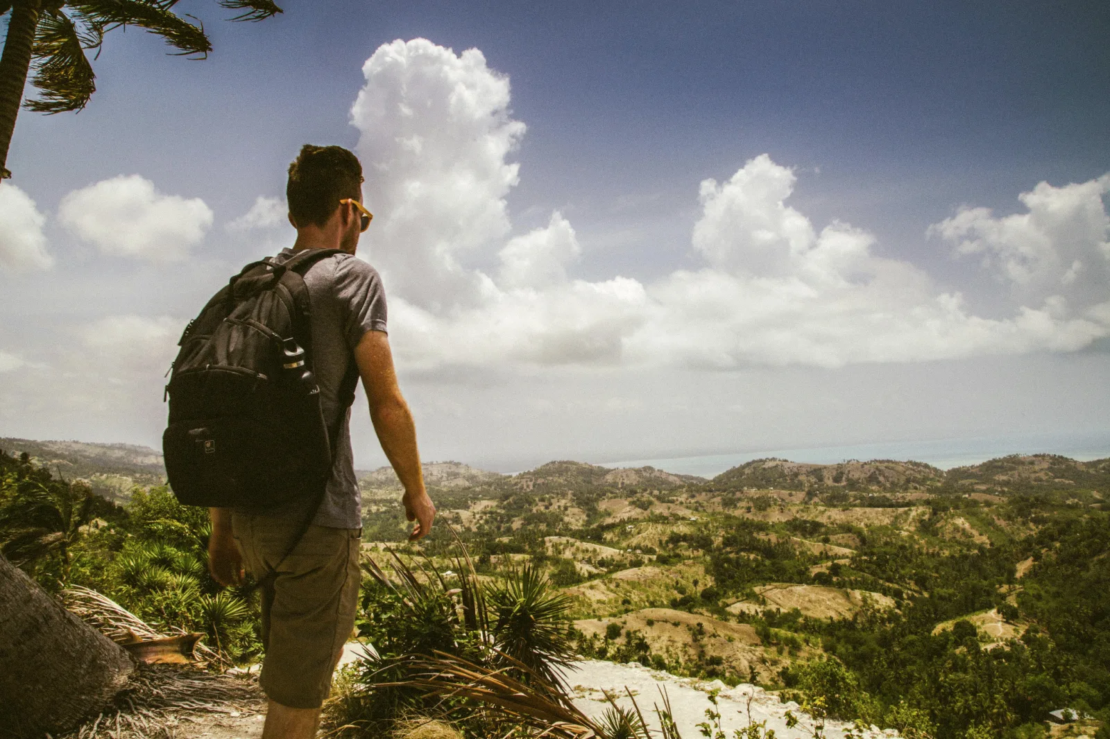 Traveller taking in a scenic hillside lookout